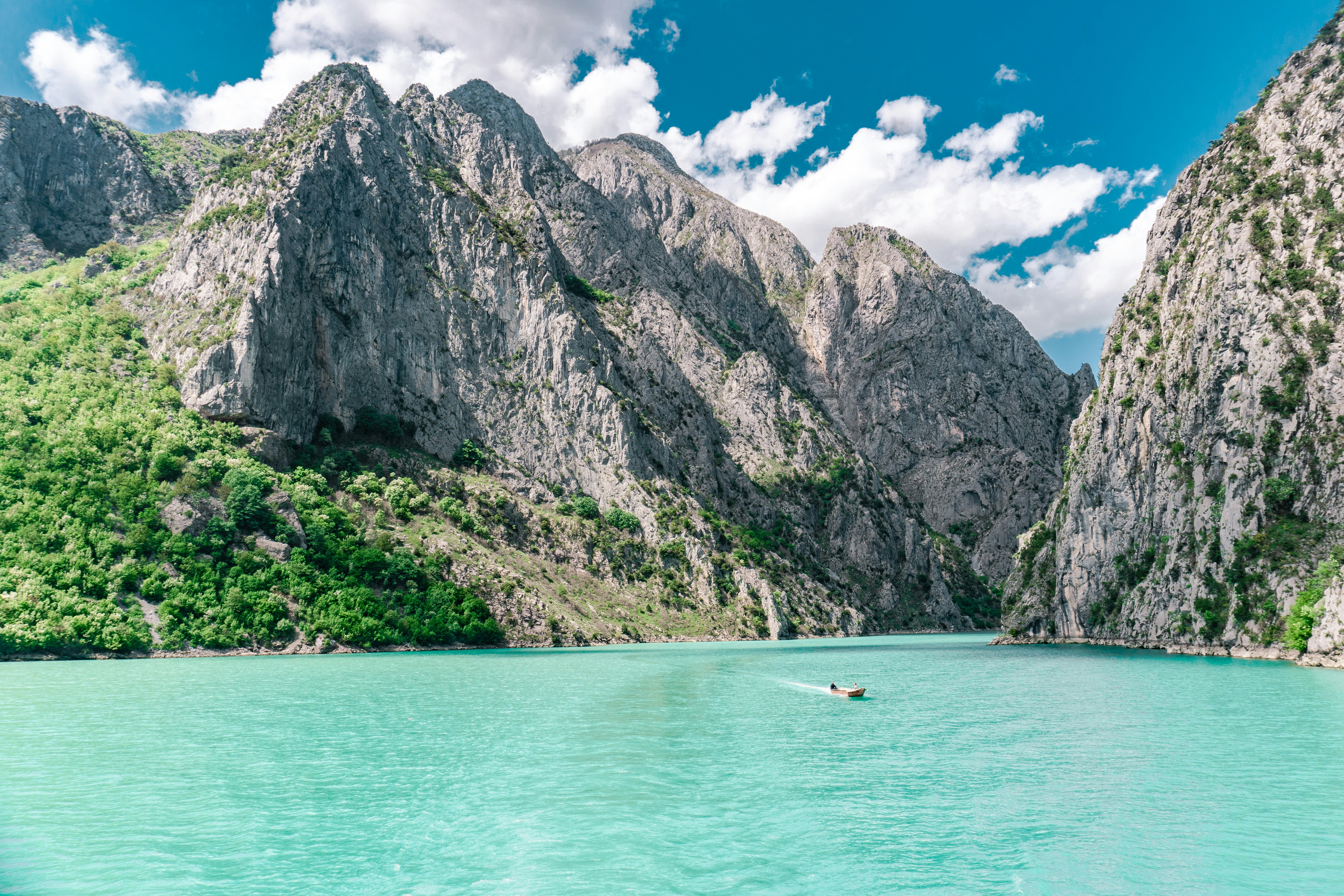 Turquoise water and dramatic karst cliffs of Komani Lake in northern Albania
