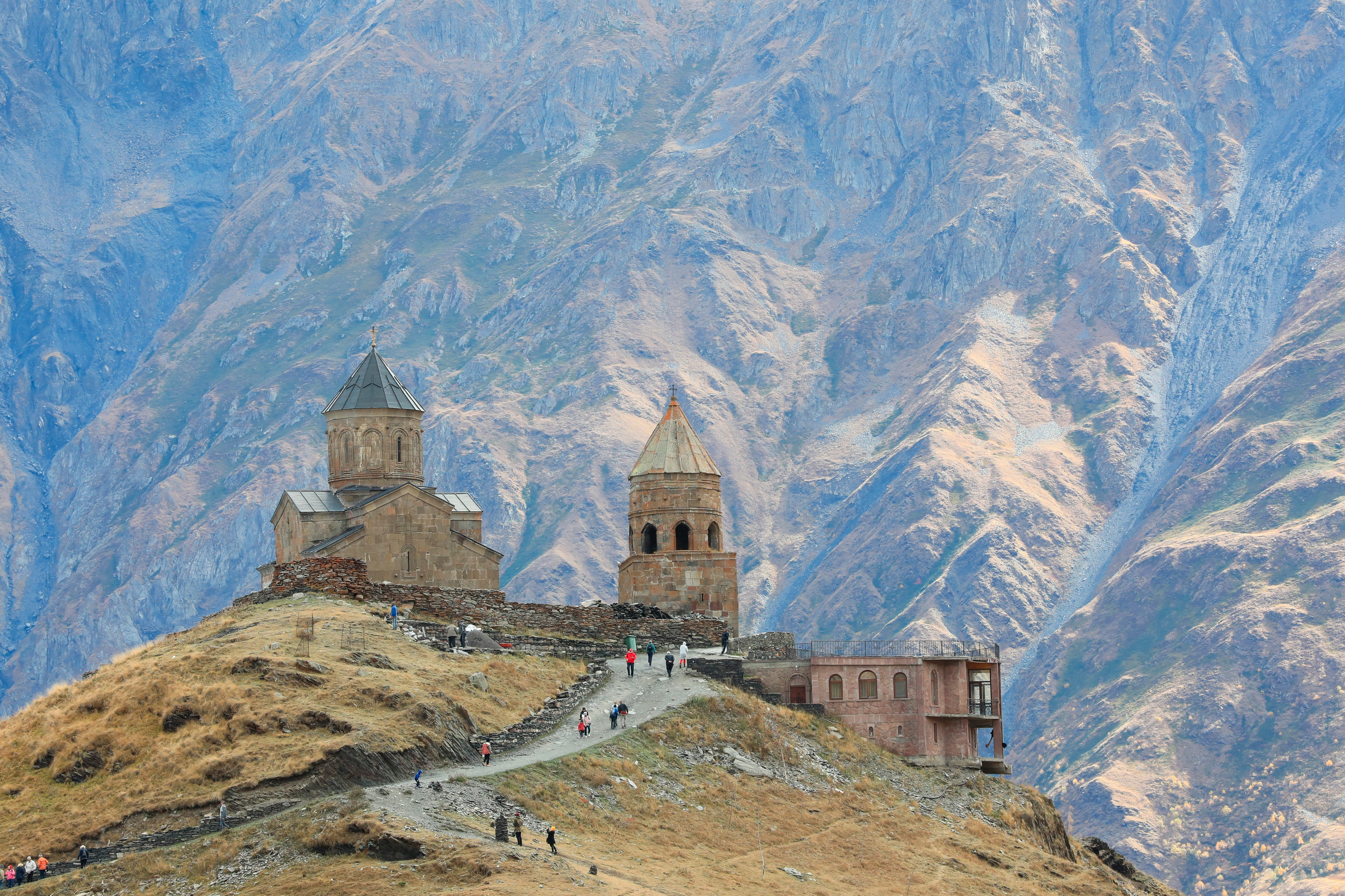 Gergeti Trinity Church on a hill in front of the Caucasus mountains, Kazbegi, Georgia