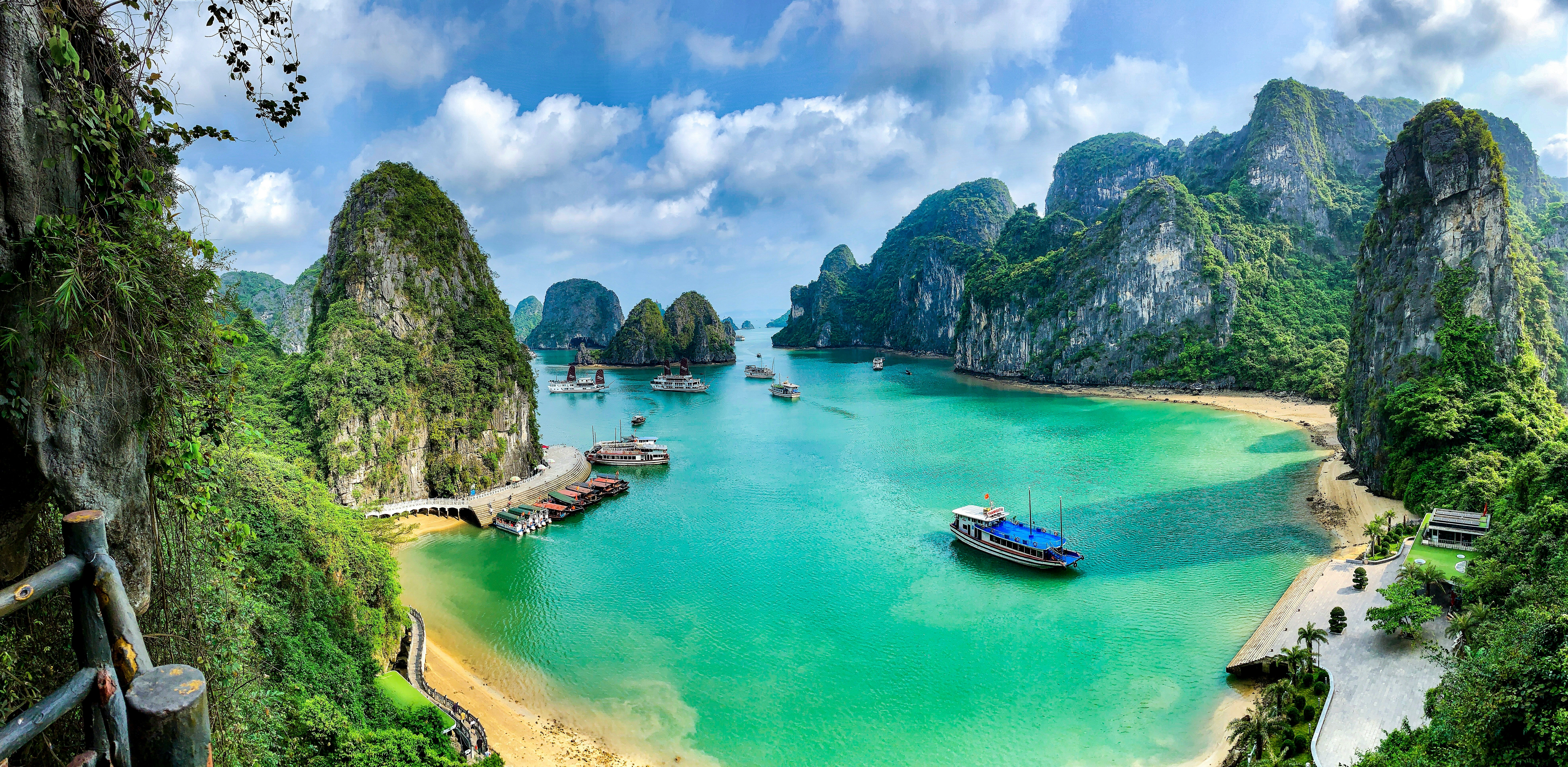 Halong Bay limestone karst islands and traditional junk boats in turquoise water, northern Vietnam